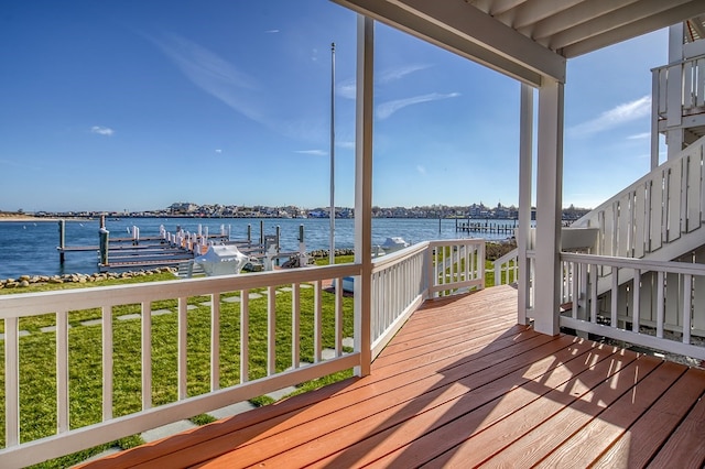 wooden terrace featuring a boat dock and a water view