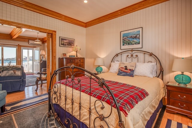 bedroom featuring ornamental molding, access to exterior, dark hardwood / wood-style flooring, and a water view