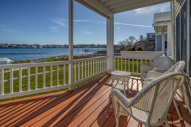 exterior space featuring a lawn and a water view