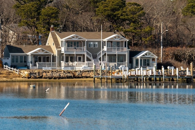 back of house featuring a balcony and a water view