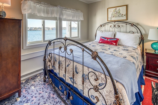 carpeted bedroom featuring baseboard heating and a water view