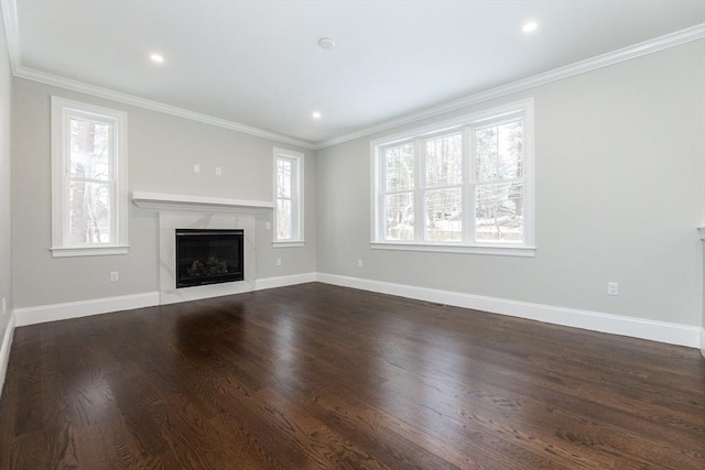 unfurnished living room featuring a healthy amount of sunlight and ornamental molding