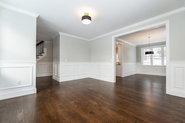 empty room with dark wood-type flooring and ornamental molding