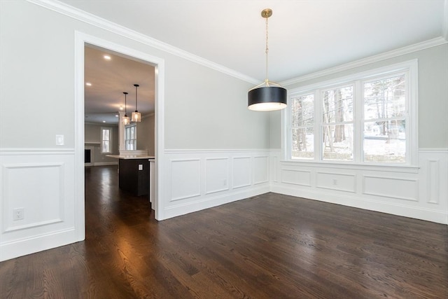 unfurnished dining area with crown molding, dark hardwood / wood-style floors, and a healthy amount of sunlight