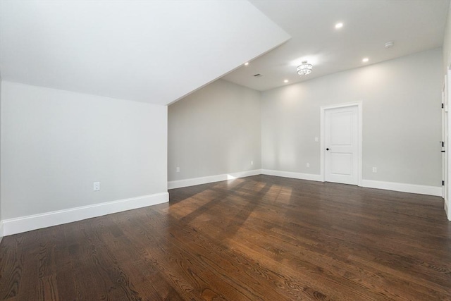 unfurnished room with dark hardwood / wood-style flooring