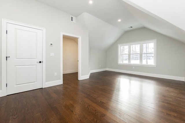 additional living space featuring lofted ceiling and dark wood-type flooring