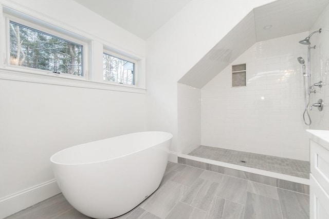 bathroom with vanity and shower with separate bathtub