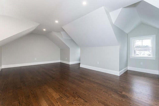 additional living space featuring lofted ceiling and dark hardwood / wood-style floors