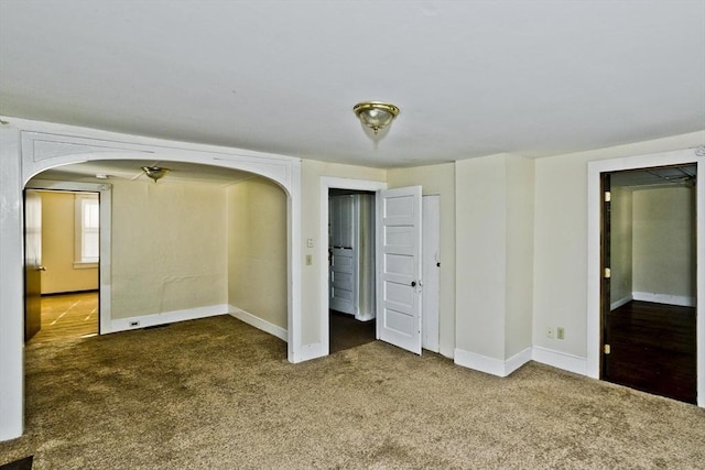 734 Main St, Amherst, MA 01002 - unfurnished bedroom with arched walkways, carpet, and baseboards