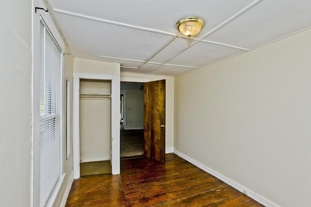 734 Main St, Amherst, MA 01002 - unfurnished bedroom with hardwood / wood-style floors, a closet, and baseboards