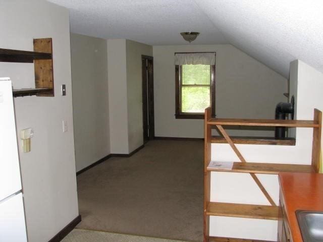 734 Main St, Amherst, MA 01002 - additional living space with vaulted ceiling, carpet, baseboards, and a textured ceiling