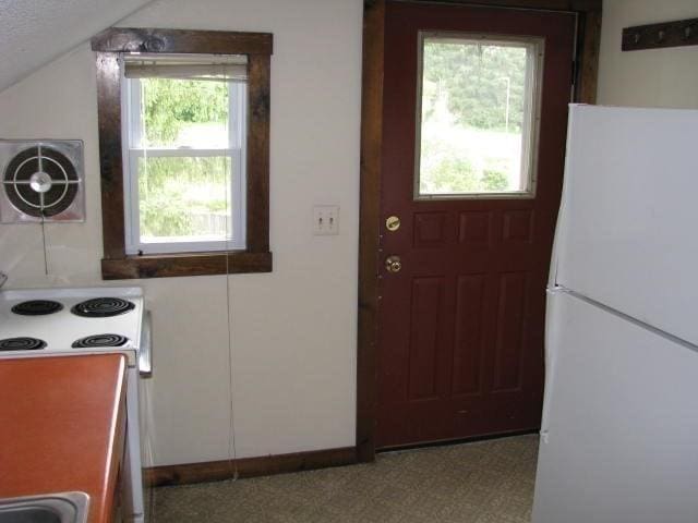 734 Main St, Amherst, MA 01002 - kitchen with white appliances, lofted ceiling, and baseboards