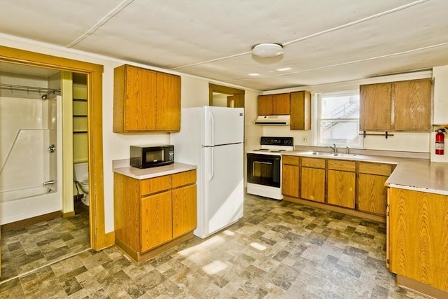 734 Main St, Amherst, MA 01002 - kitchen with electric range oven, black microwave, exhaust hood, freestanding refrigerator, and brown cabinets
