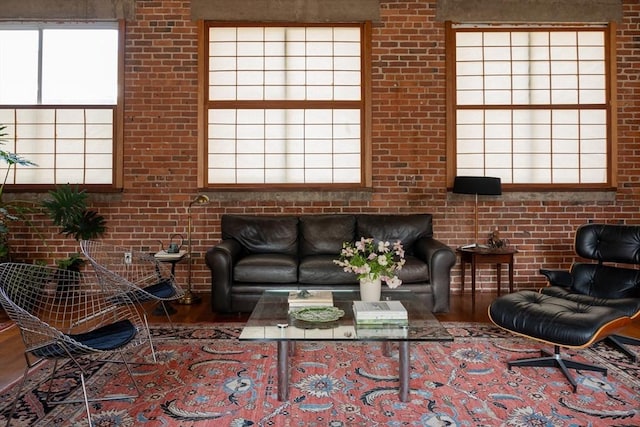 543 Green St, Cambridge, MA 02139 - living area featuring wood finished floors, plenty of natural light, and brick wall