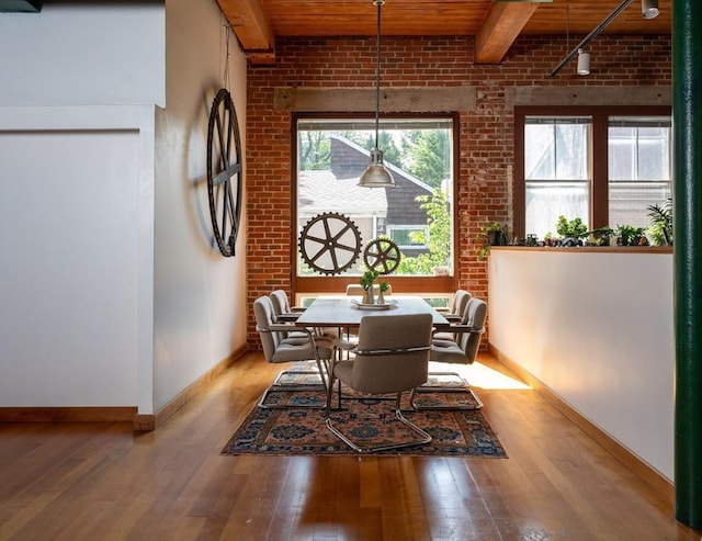 543 Green St, Cambridge, MA 02139 - dining room with hardwood / wood-style flooring, a wood ceiling with exposed beams, brick wall, and rail lighting