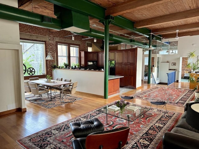 543 Green St, Cambridge, MA 02139 - living room with brick wall, light wood-style flooring, and a wooden ceiling with exposed beams