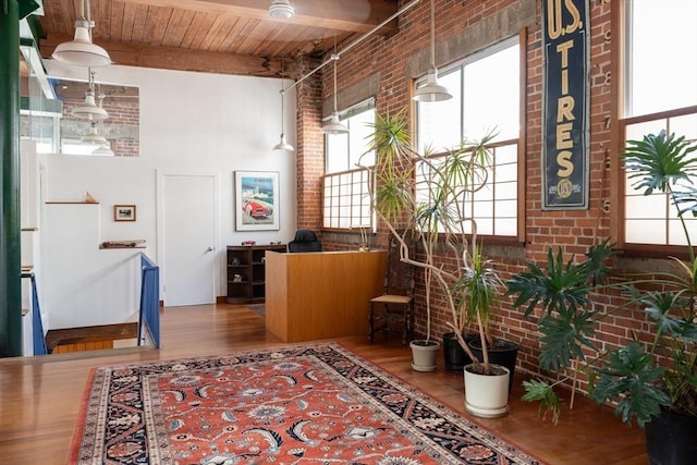 543 Green St, Cambridge, MA 02139 - hall with brick wall, wood finished floors, a wood ceiling with exposed beams, and a high ceiling