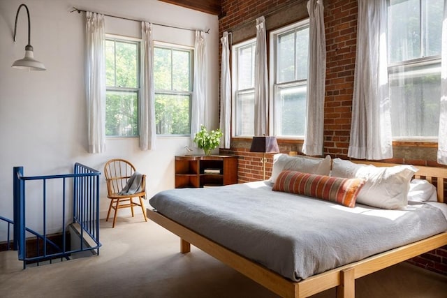 543 Green St, Cambridge, MA 02139 - bedroom with carpet flooring and brick wall