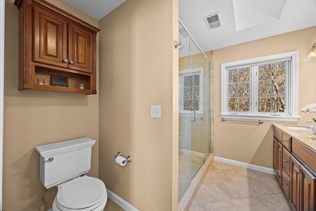 bathroom with vanity, a shower with shower door, and toilet