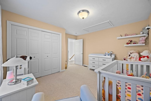 carpeted bedroom with a closet and a nursery area