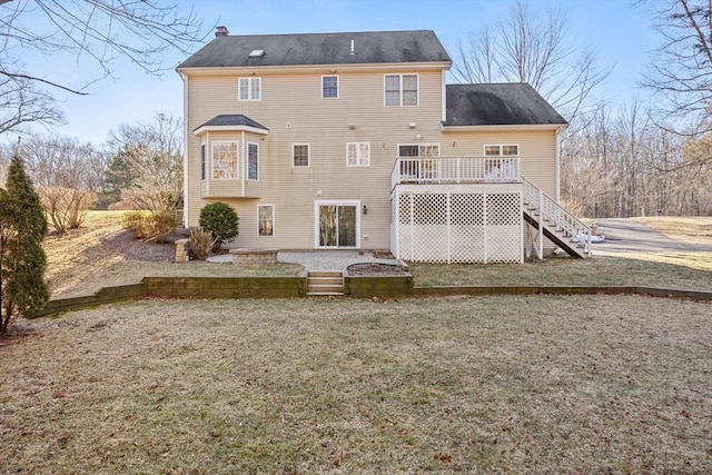 back of house with a yard and a deck