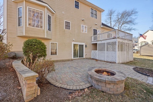 back of house with a patio and a fire pit