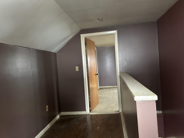 corridor featuring hardwood / wood-style flooring and lofted ceiling