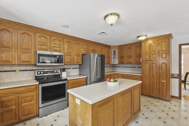 kitchen with appliances with stainless steel finishes and a kitchen island