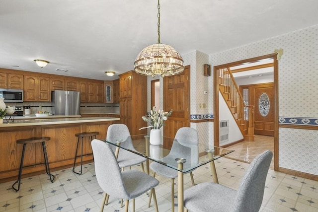 dining space featuring a chandelier