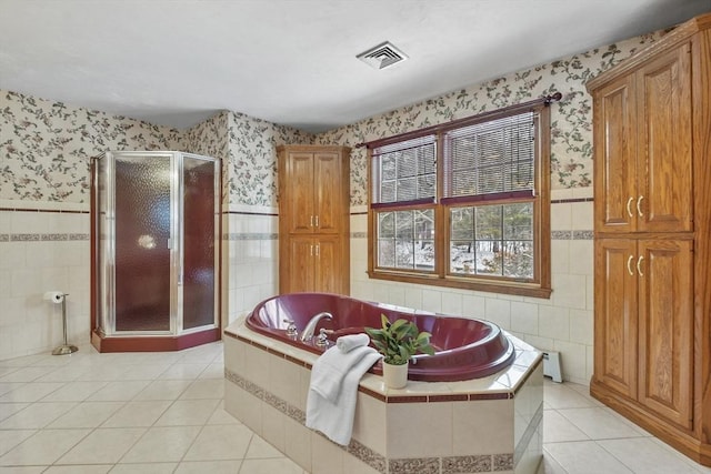 bathroom featuring tile walls, tile patterned flooring, and shower with separate bathtub