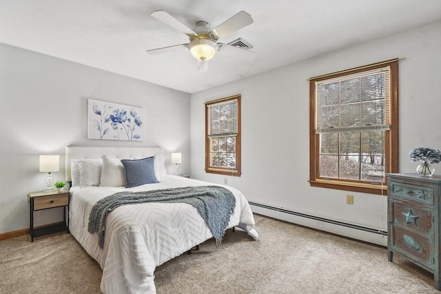 carpeted bedroom featuring a baseboard heating unit and ceiling fan