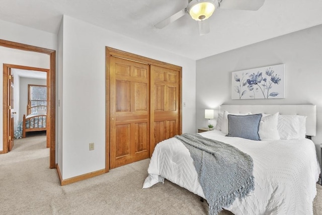 carpeted bedroom with a closet and ceiling fan