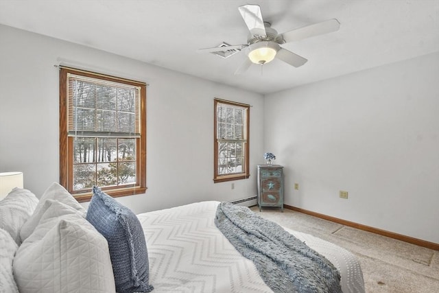 bedroom featuring ceiling fan, carpet floors, and a baseboard heating unit