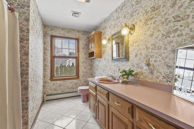 bathroom with plenty of natural light, tile patterned flooring, vanity, and a baseboard radiator