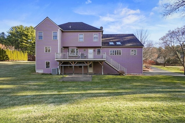 back of house featuring central AC unit, a lawn, and a wooden deck