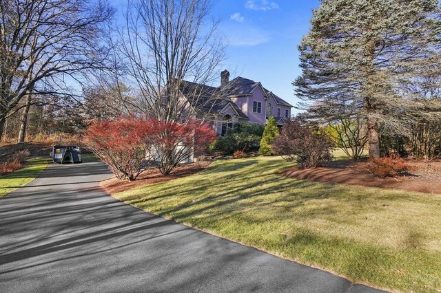 view of property exterior featuring a lawn