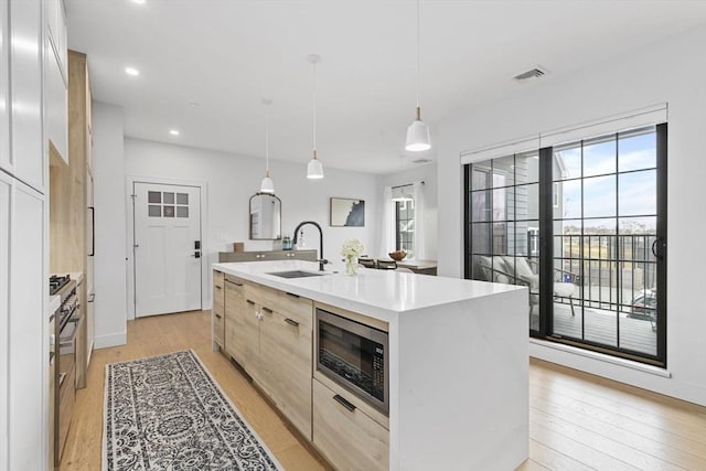 4 Payne St One, Unit One, Boston, MA 02122 - kitchen featuring stainless steel microwave, a sink, light wood-style floors, plenty of natural light, and recessed lighting