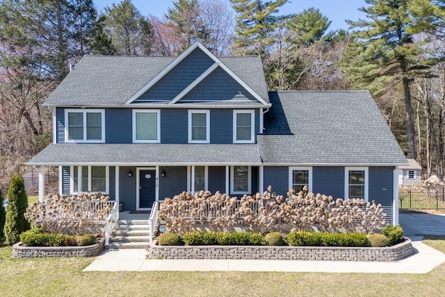 view of front of house featuring a porch and a shingled roof