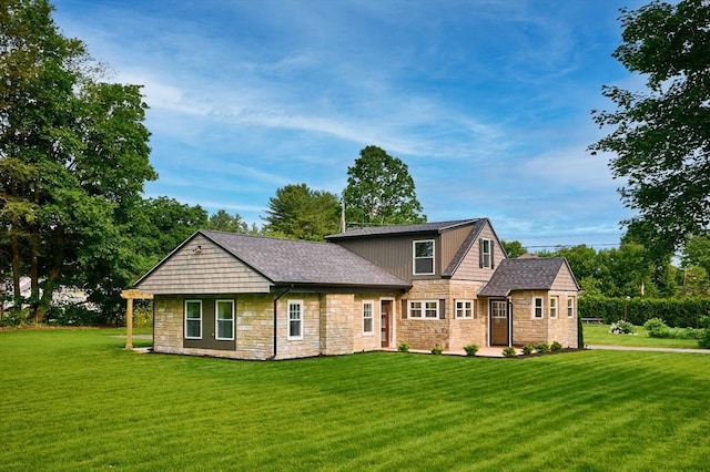 116 Holyoke St, Easthampton, MA 01027 - view of front of house featuring stone siding and a front lawn