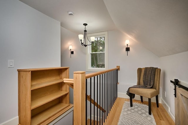 116 Holyoke St, Easthampton, MA 01027 - sitting room with light wood-style flooring, an upstairs landing, vaulted ceiling, and a chandelier