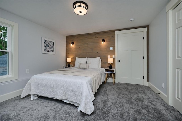 116 Holyoke St, Easthampton, MA 01027 - bedroom with dark colored carpet and wooden walls
