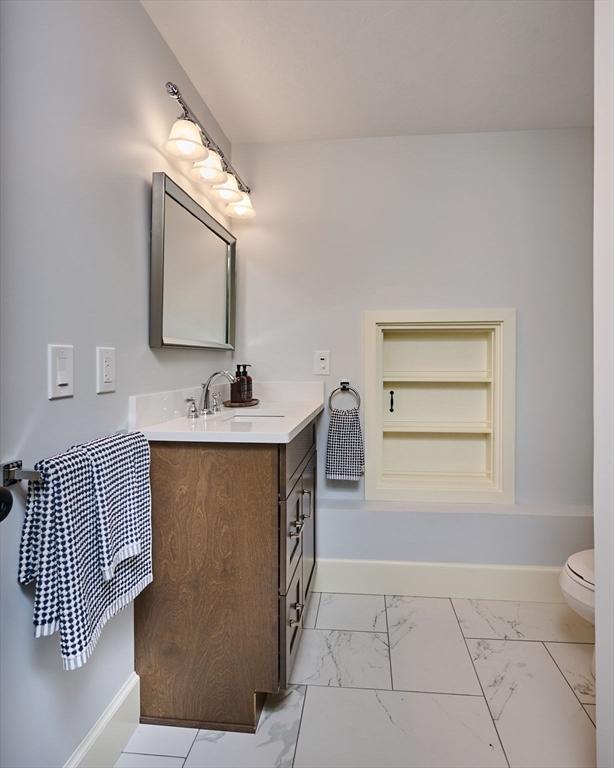116 Holyoke St, Easthampton, MA 01027 - bathroom with vanity, marble finish flooring, and built in shelves