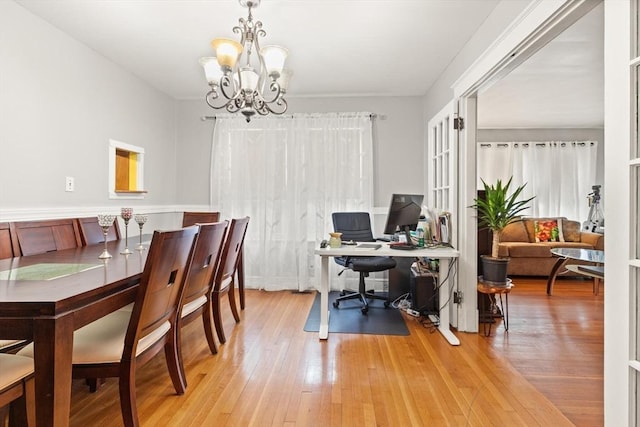 office area with a chandelier and light wood-style flooring