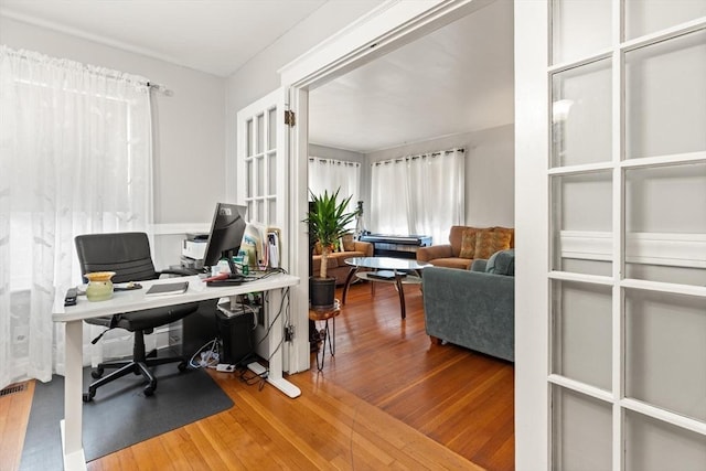 home office featuring hardwood / wood-style flooring and french doors