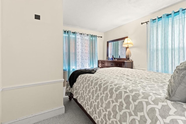 carpeted bedroom with baseboards