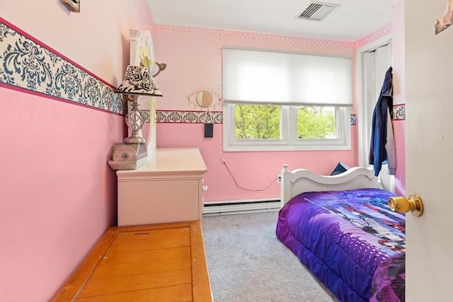 carpeted bedroom with a baseboard radiator