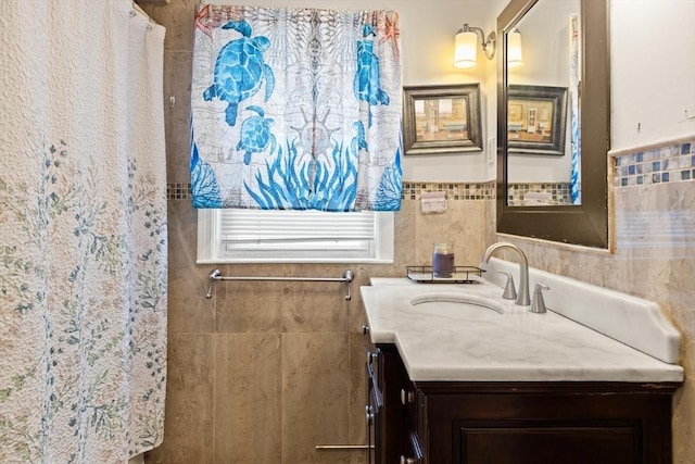 bathroom featuring vanity, tile walls, and wainscoting