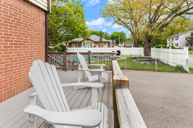 deck featuring fence and a residential view