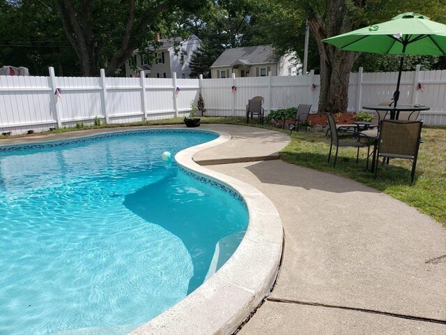view of pool featuring a fenced backyard and a patio