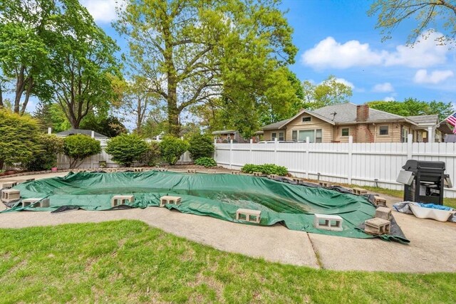 view of home's community featuring a fenced backyard and a pool